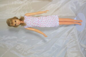 blonde francie doll in white mod dress from the 1960s with pink squares, original design of mattel